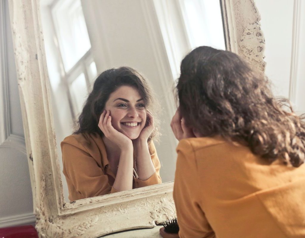 Girl smiling in a mirror