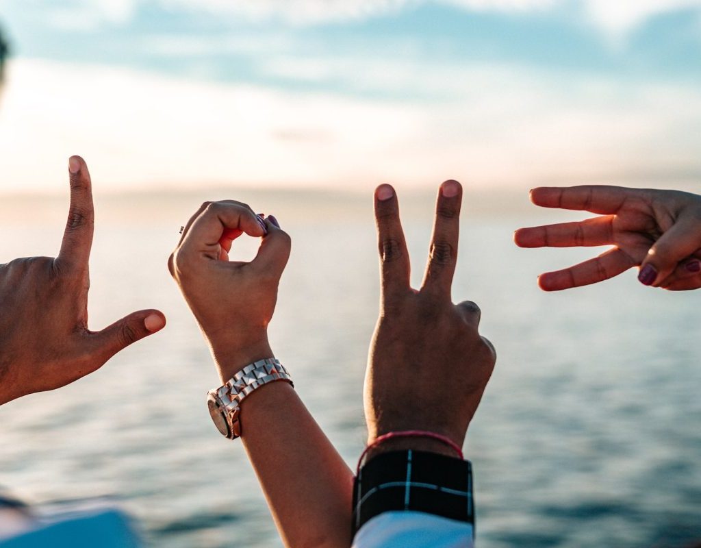 Hands holding up the letters to spell out the word "love,"