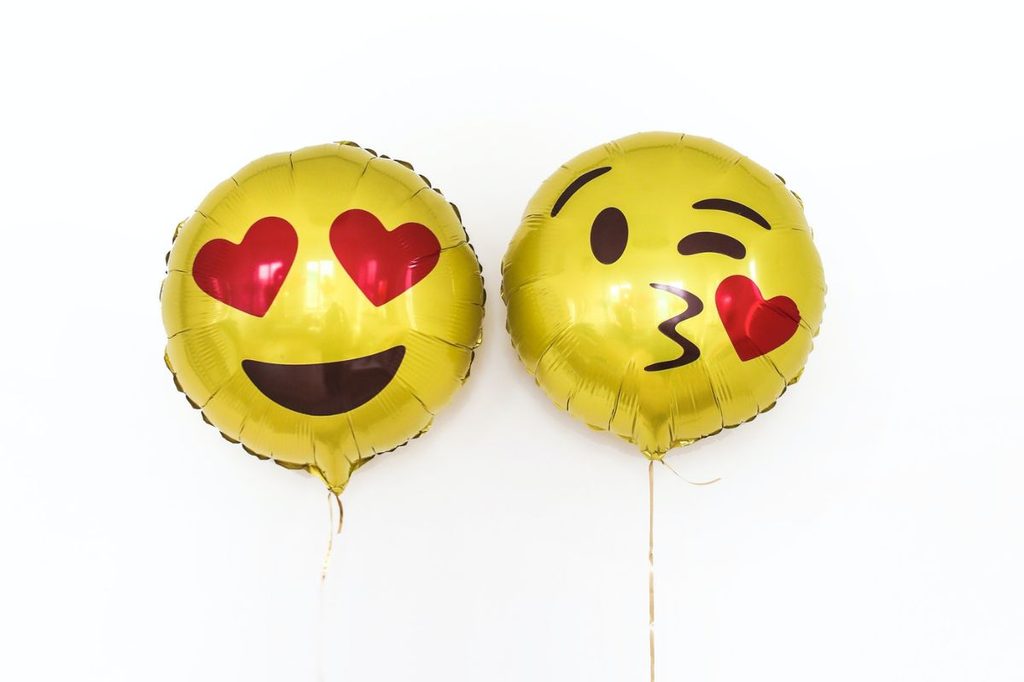 two emoji heart face balloons