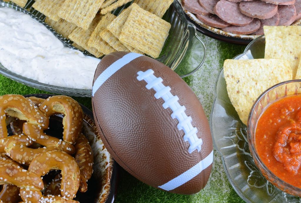 Table filled with snacks ready for family football movies