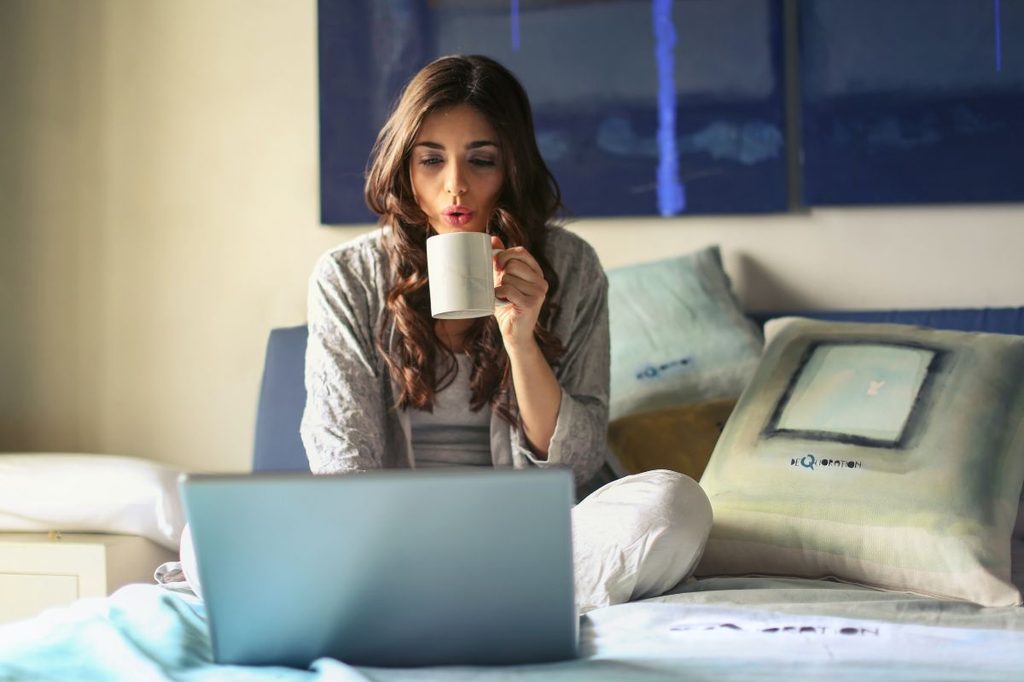 Woman with coffee and laptop