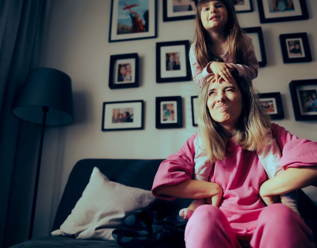 A child sitting on their parent's shoulders.