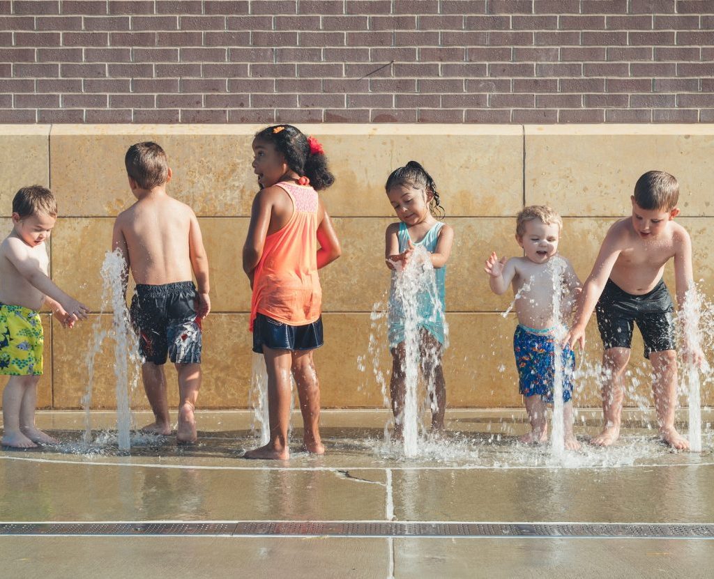 Kids playing outside at a splash pad