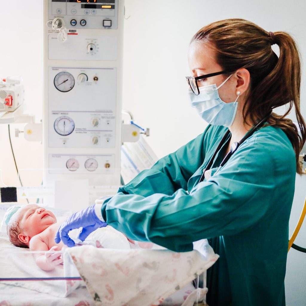 A nurse doing a check on a newborn