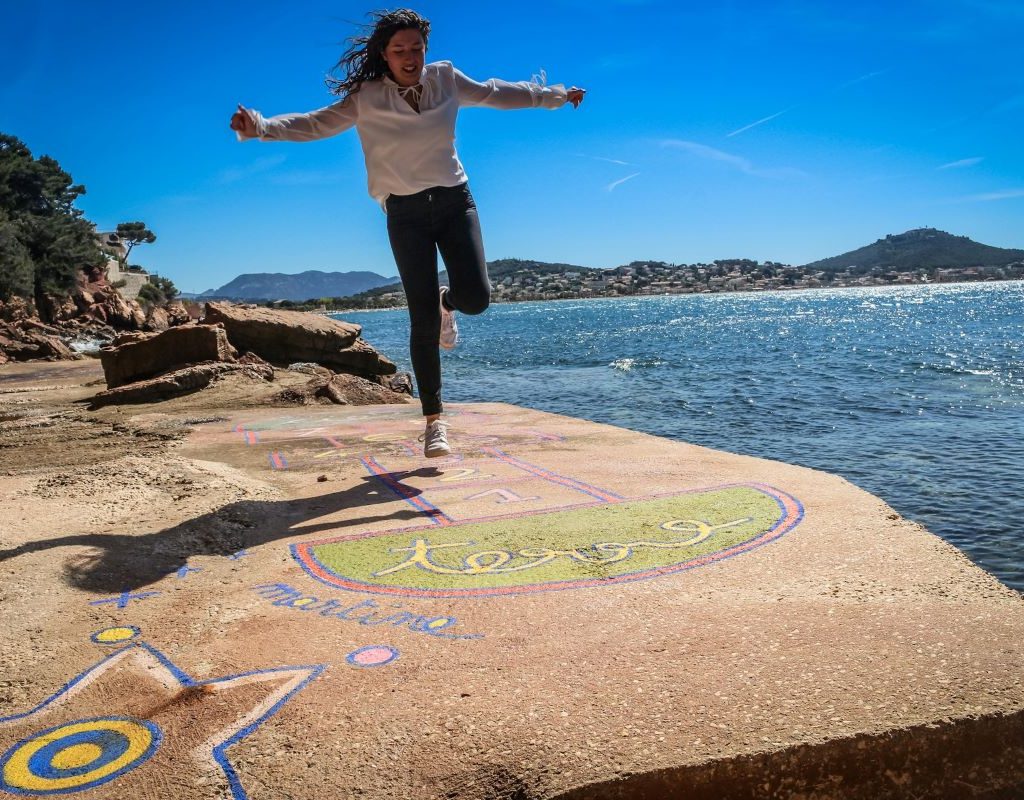 Teen enjoying herself playing hopscotch
