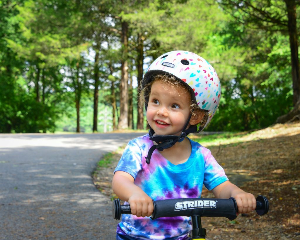 A child wearing a tie-dye shirt.