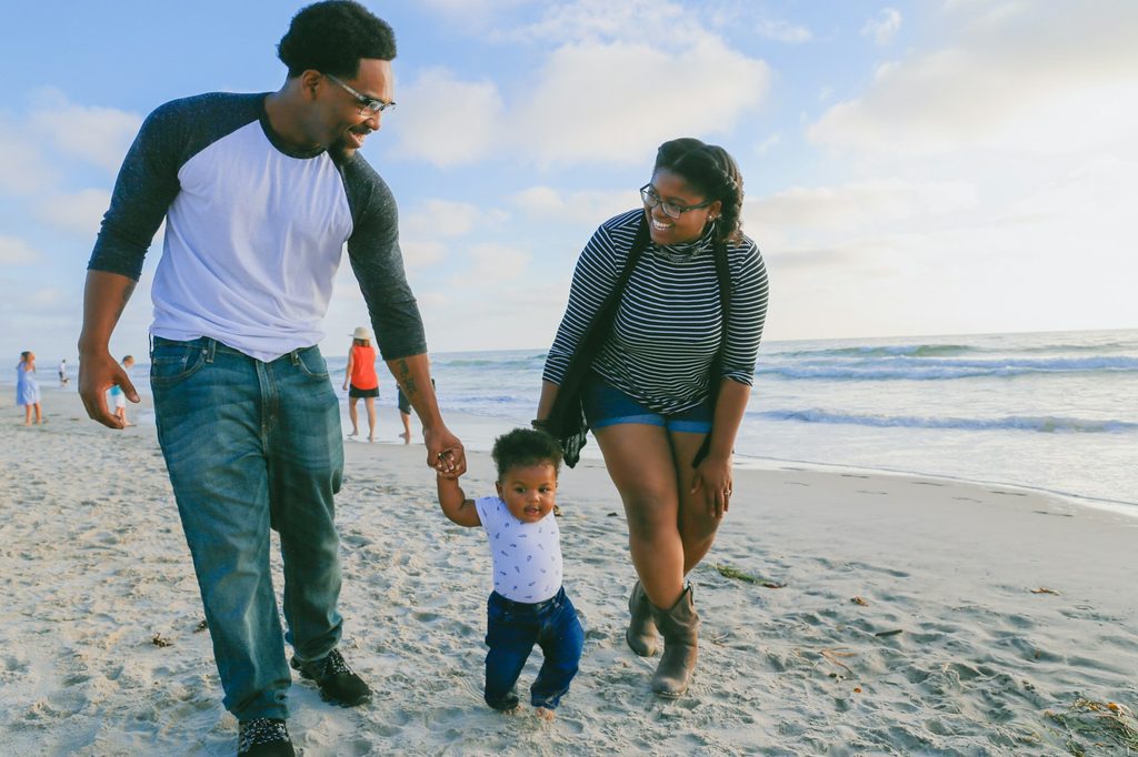 A family walking along the beach.