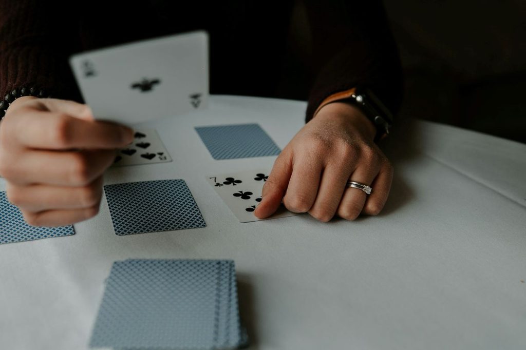 person playing card games at a table