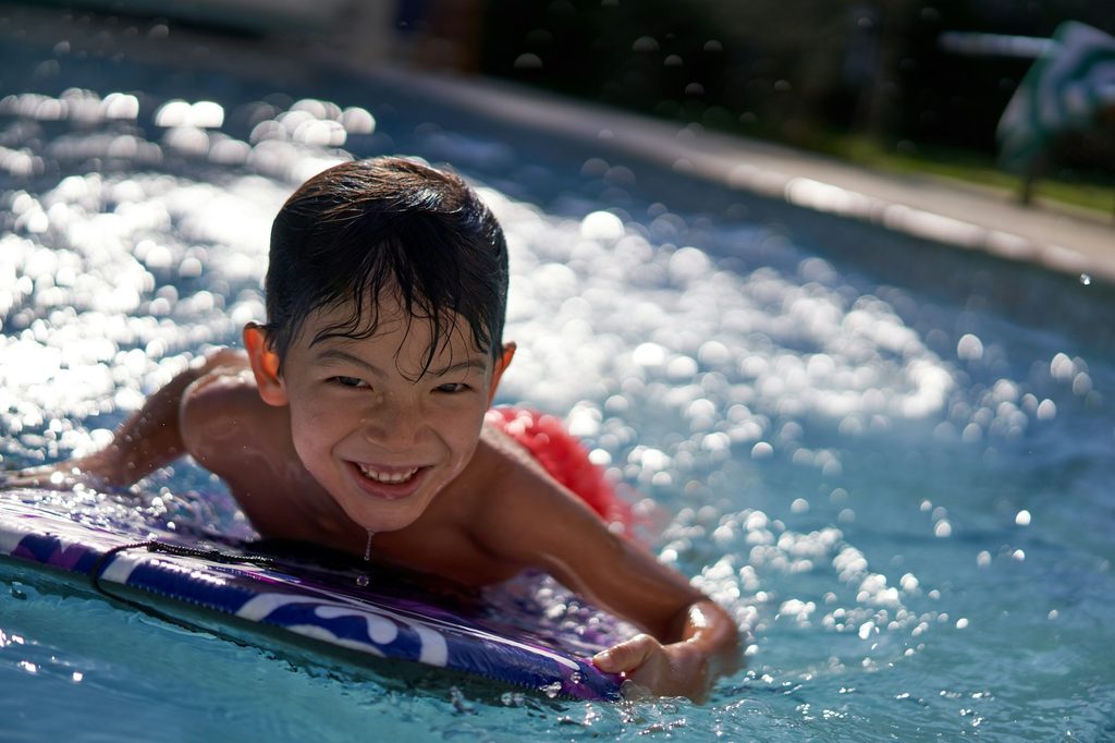 A child in the water on a water board.