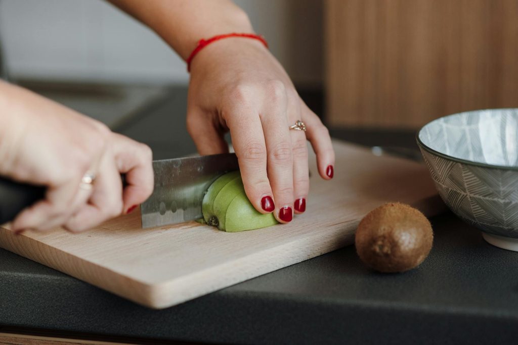 person slicing an apple
