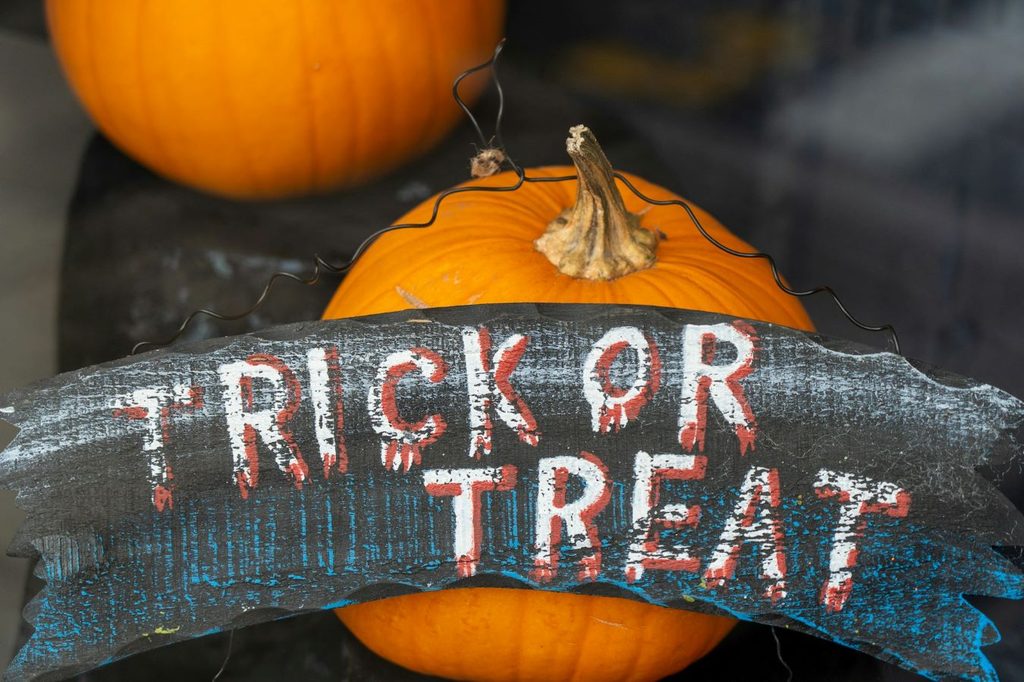 pumpkins with a trick or treat sign