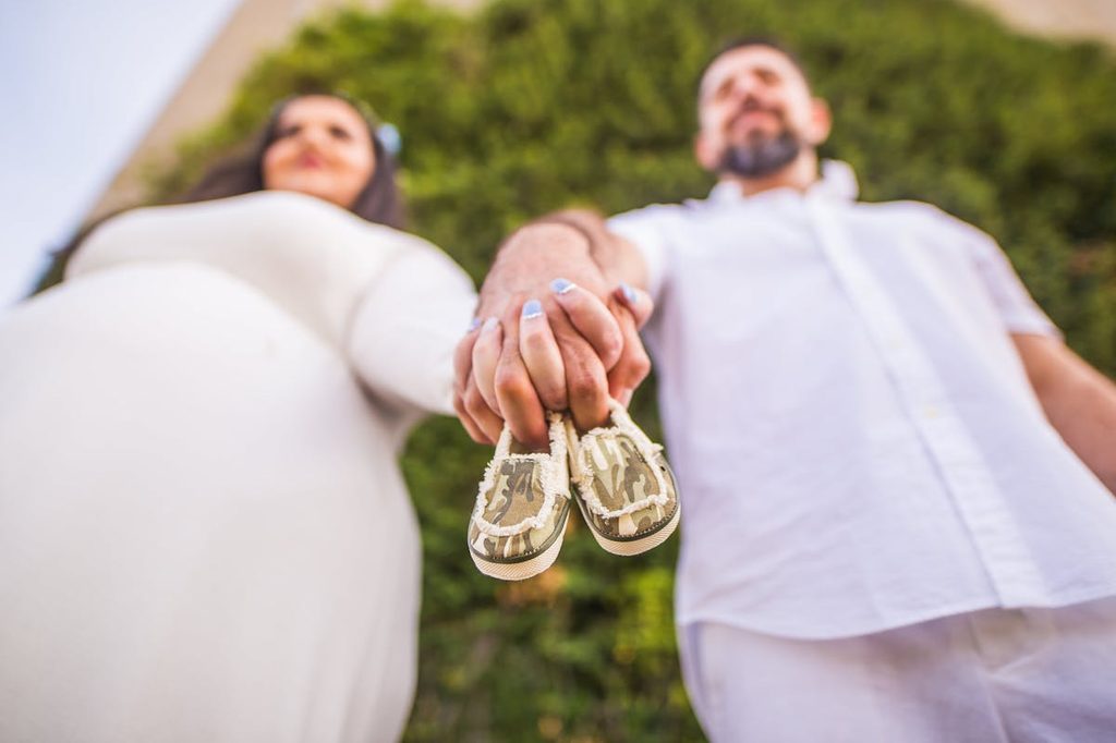 a couple baby announcement with small shoes