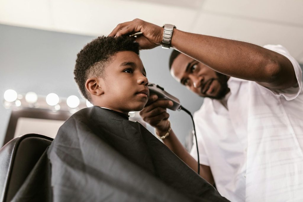 A boy getting his haircut.