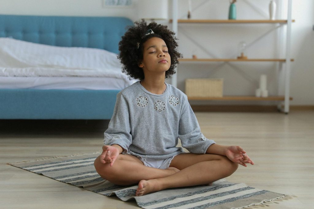 A child practicing mindfulness meditation.