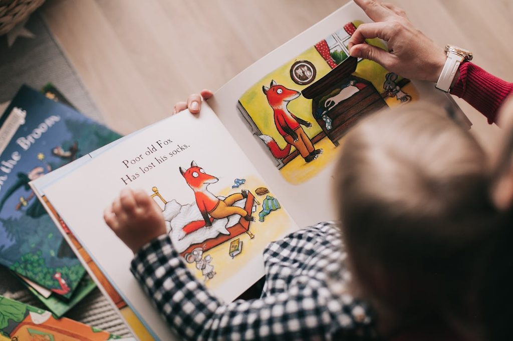 small child reading fox book