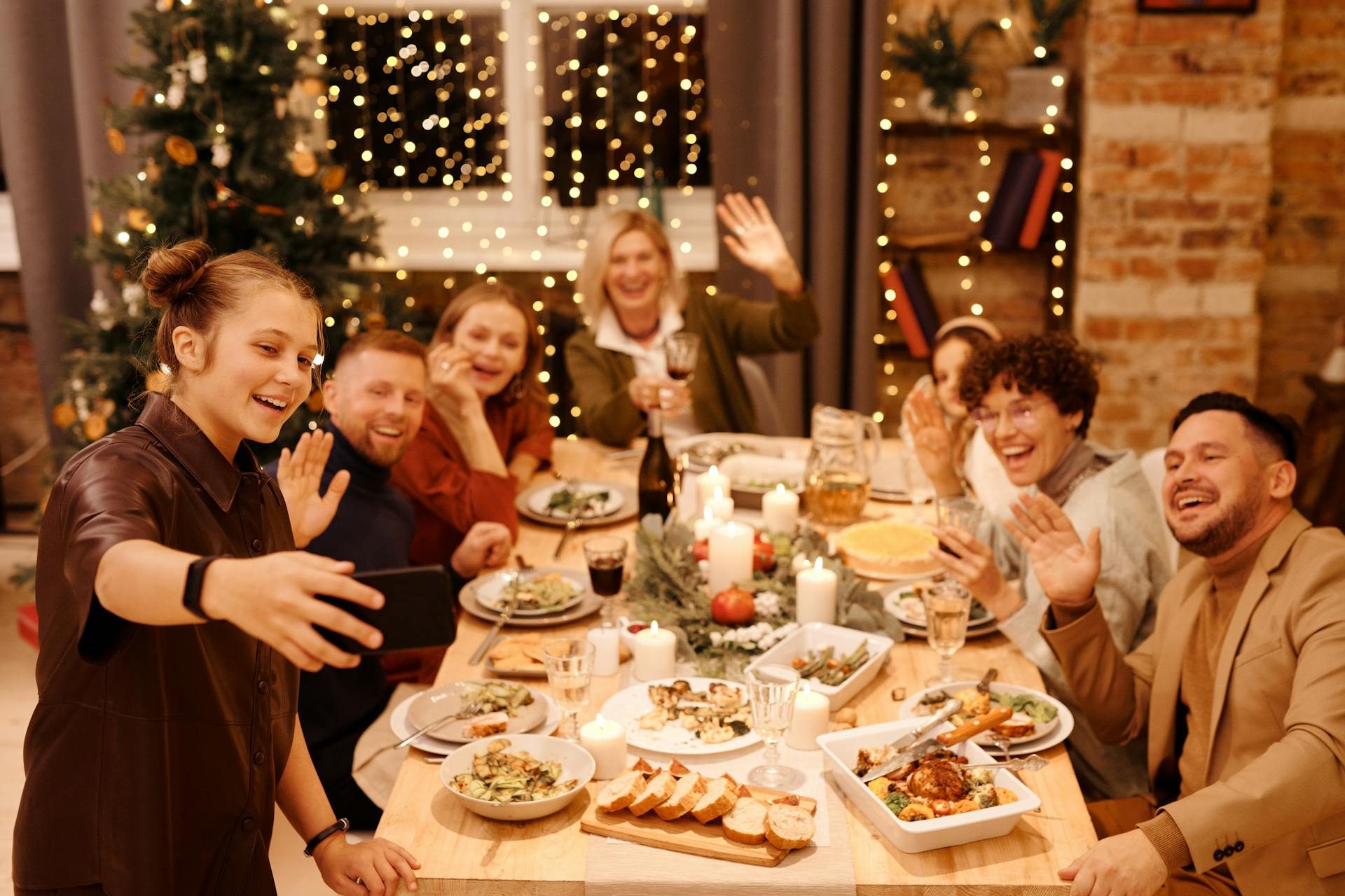 Family posing for pictures around the holiday table