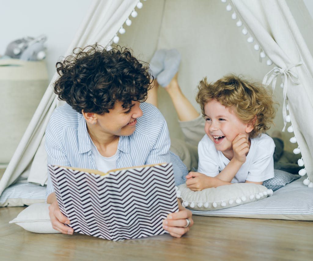 Mother and son reading a book together.