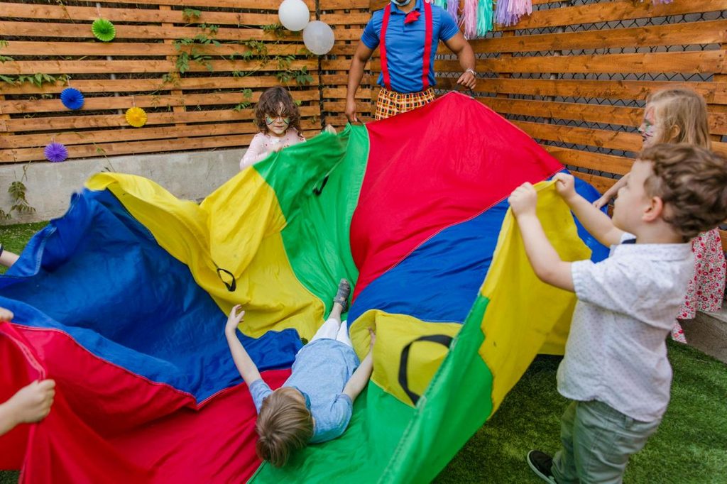 Kids playing parachute games at a birthday party