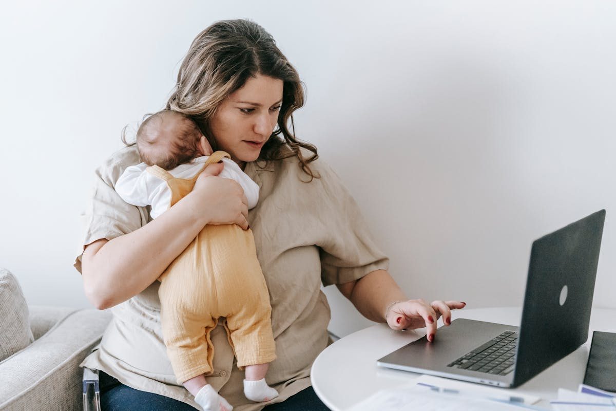mom holding baby on computer