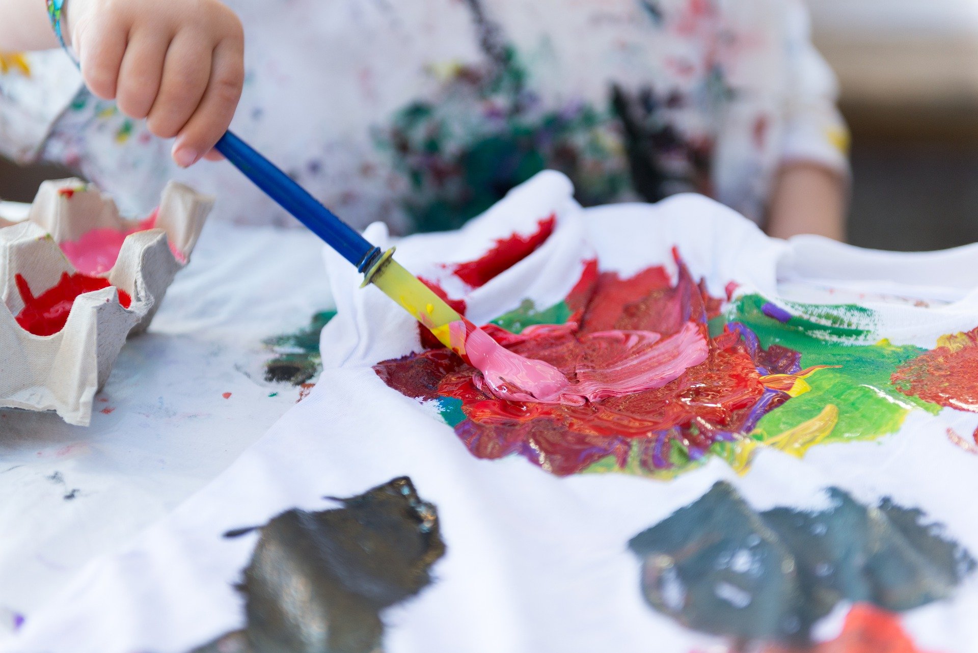 child using egg cartons to paint
