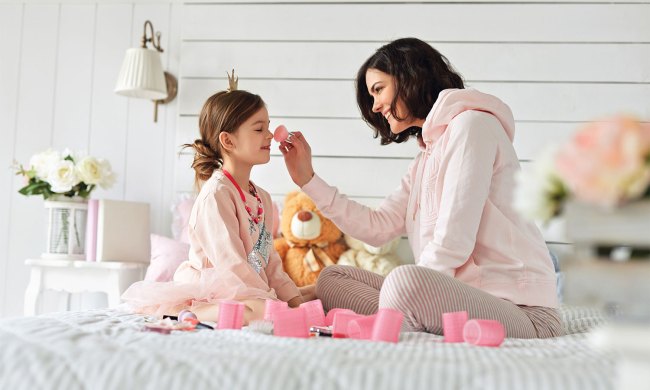 Mother and daughter playing with makeup