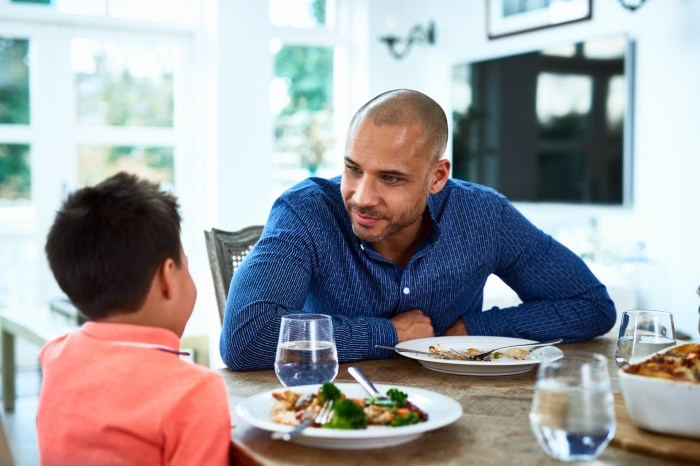 Father and son sitting at table