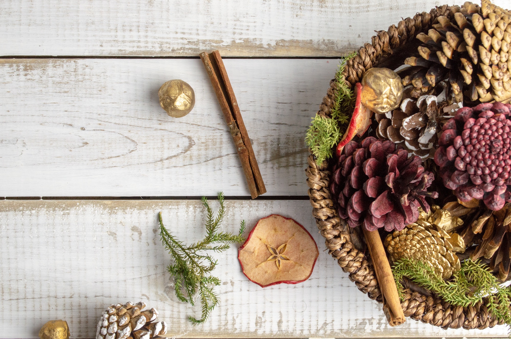 basket with natural elements like dried fruit and pinecones