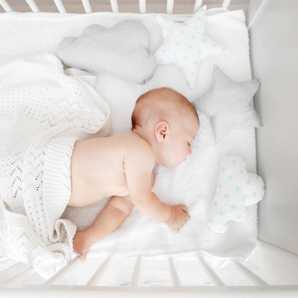 baby sleeping in white crib