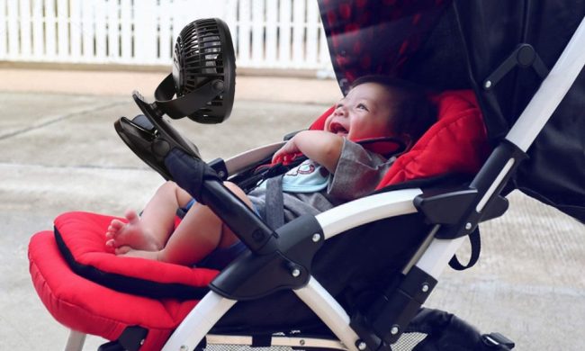 Baby lying in stroller smiling