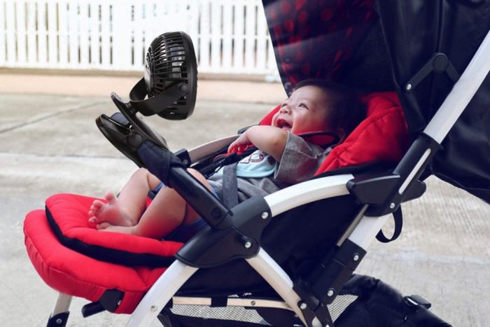 Baby lying in stroller smiling