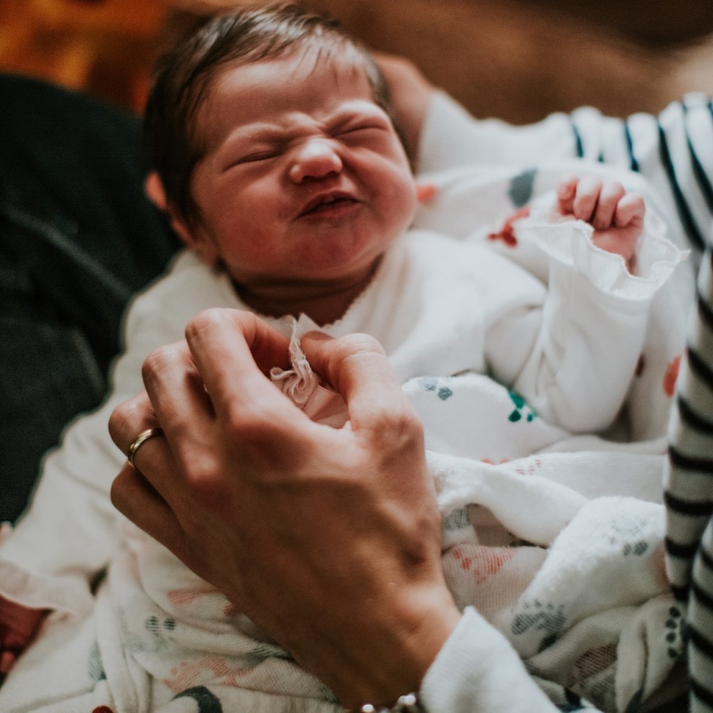 Crying baby being soothed by mother
