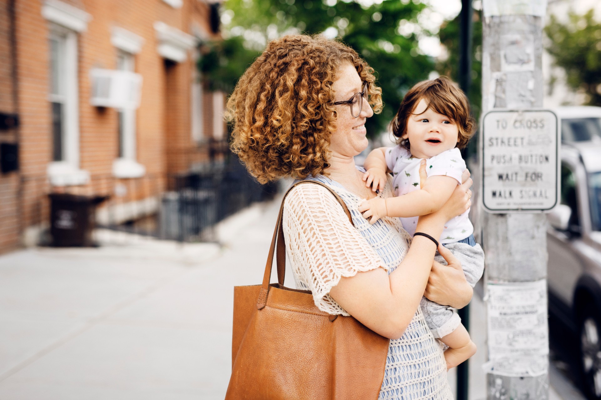 Adult carrying child and bag