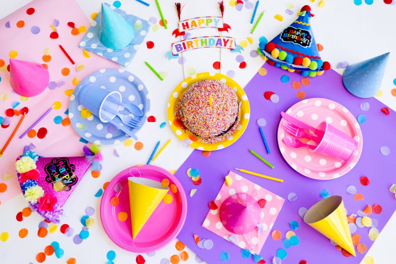 Colorful birthday party table with plates and food