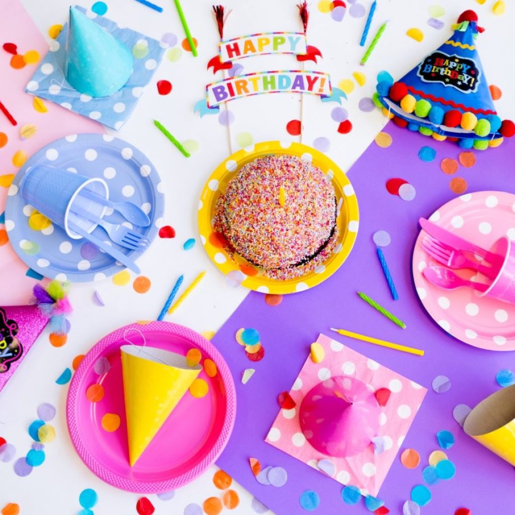 Colorful birthday party table with plates and food
