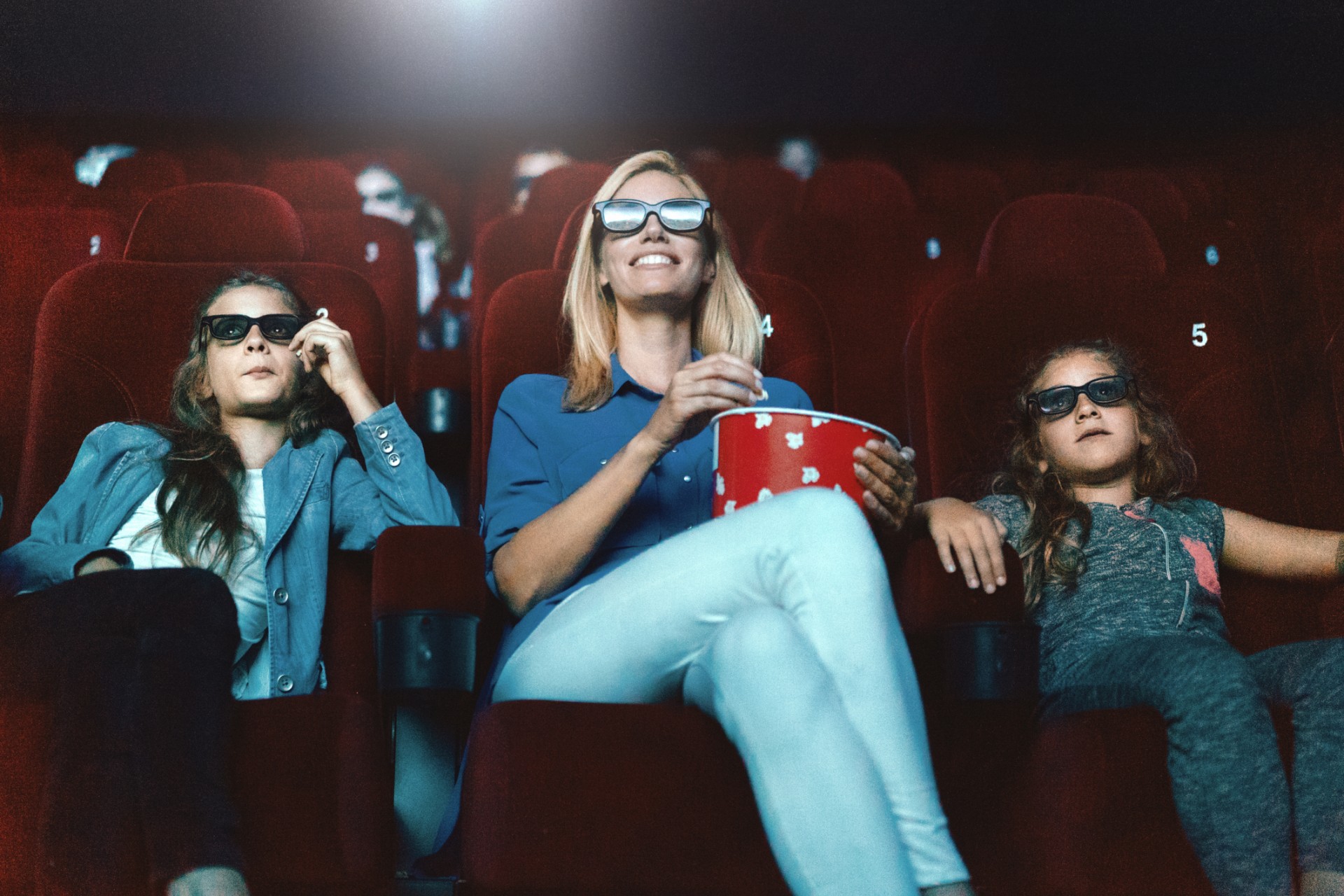 Mother and two daughters at a 3D movie