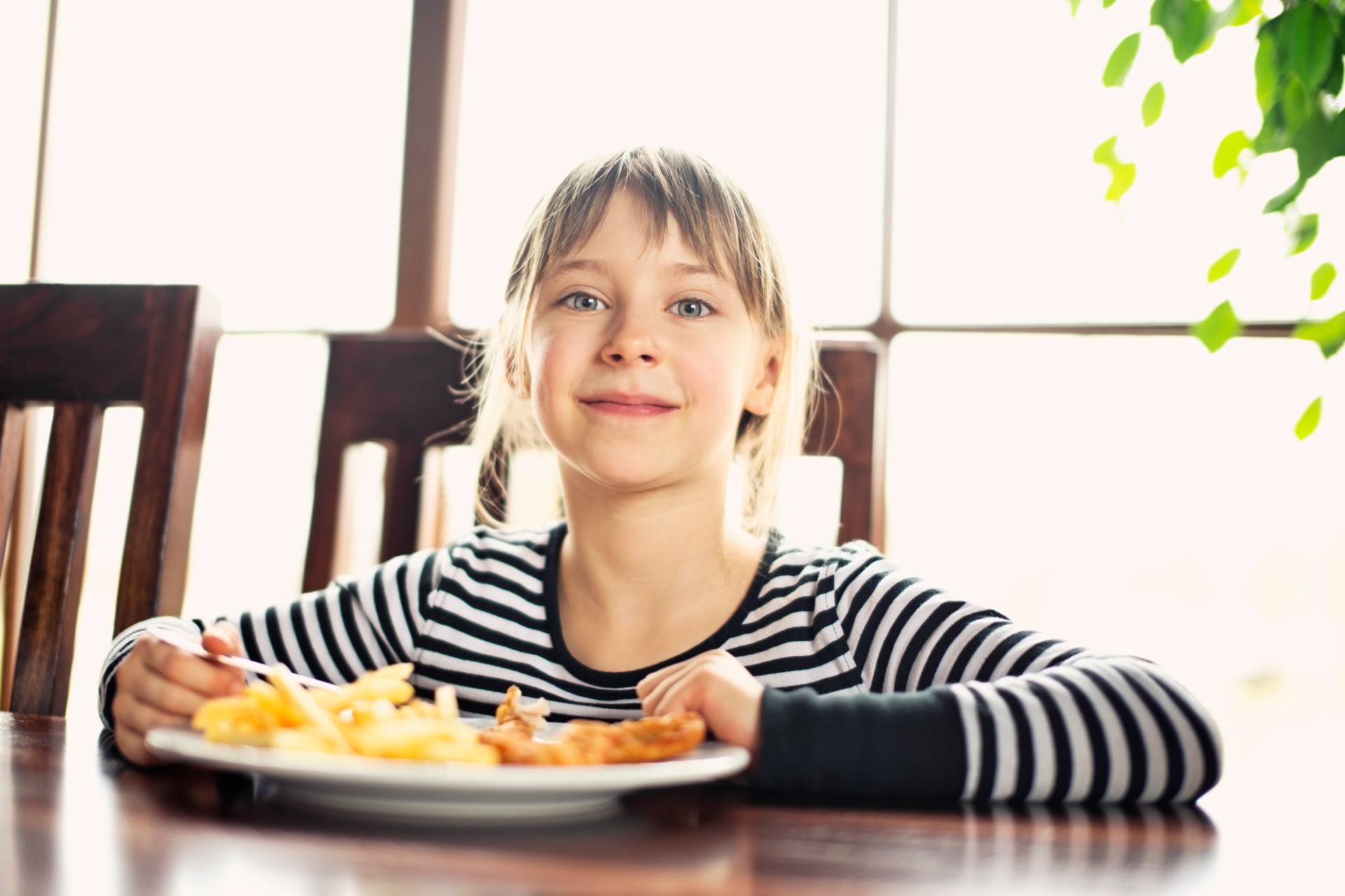 Young girl at table with takeout meal