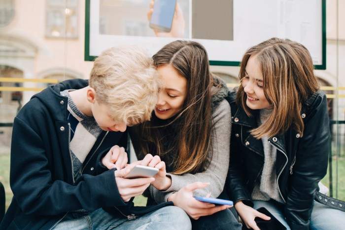 Teenagers looking at a smartphone
