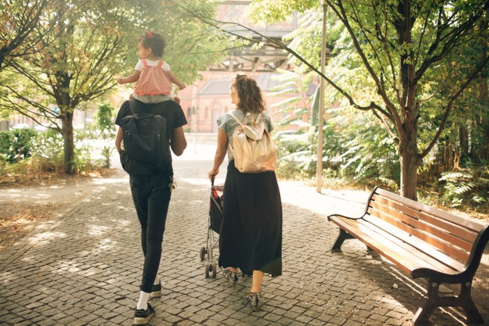 Parents with a child carrying a bag