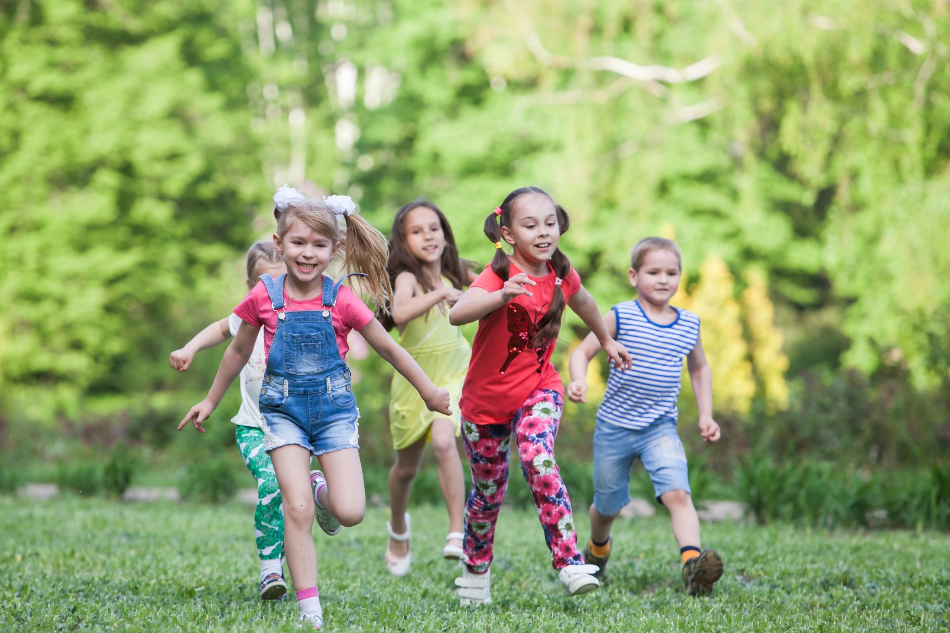 Group of children running in capture the flag in a park