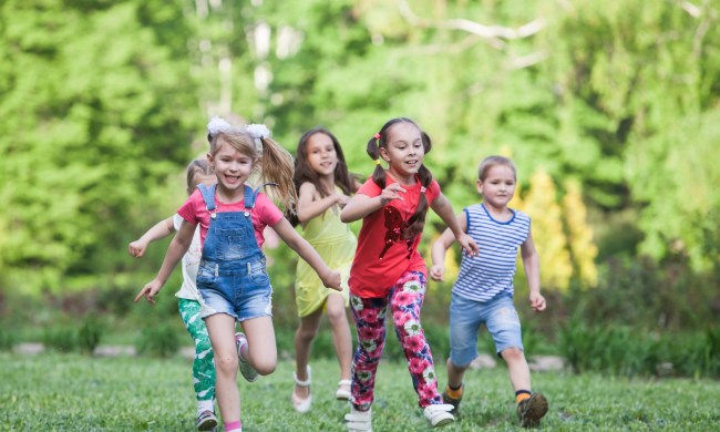 Group of children running in capture the flag in a park