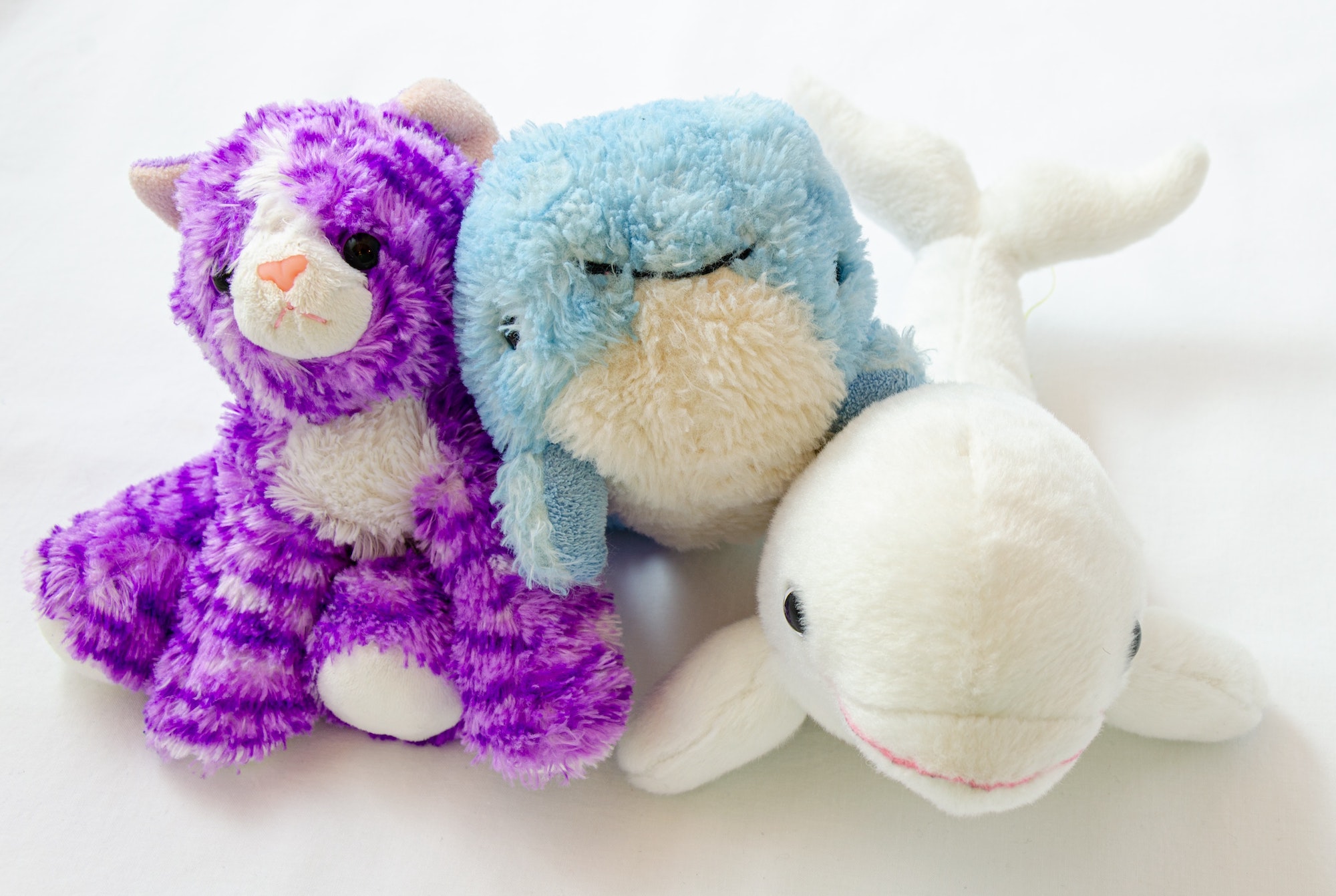 three stuffed animals next to each other