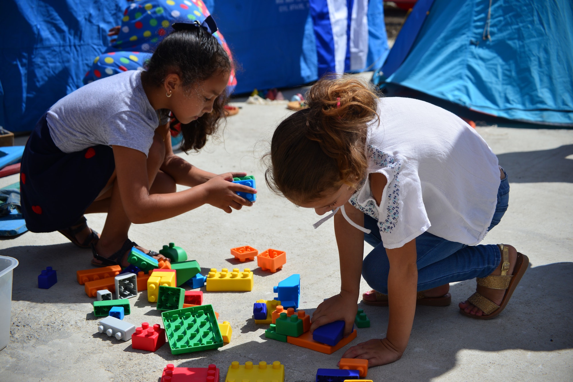 two girls playing with Legos
