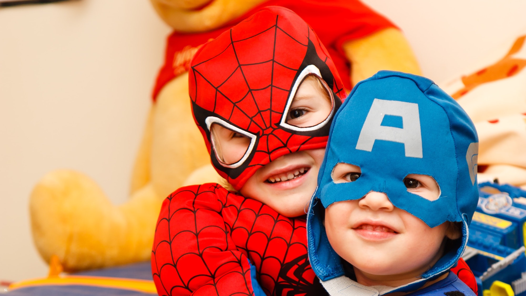Two kids in superhero costumes