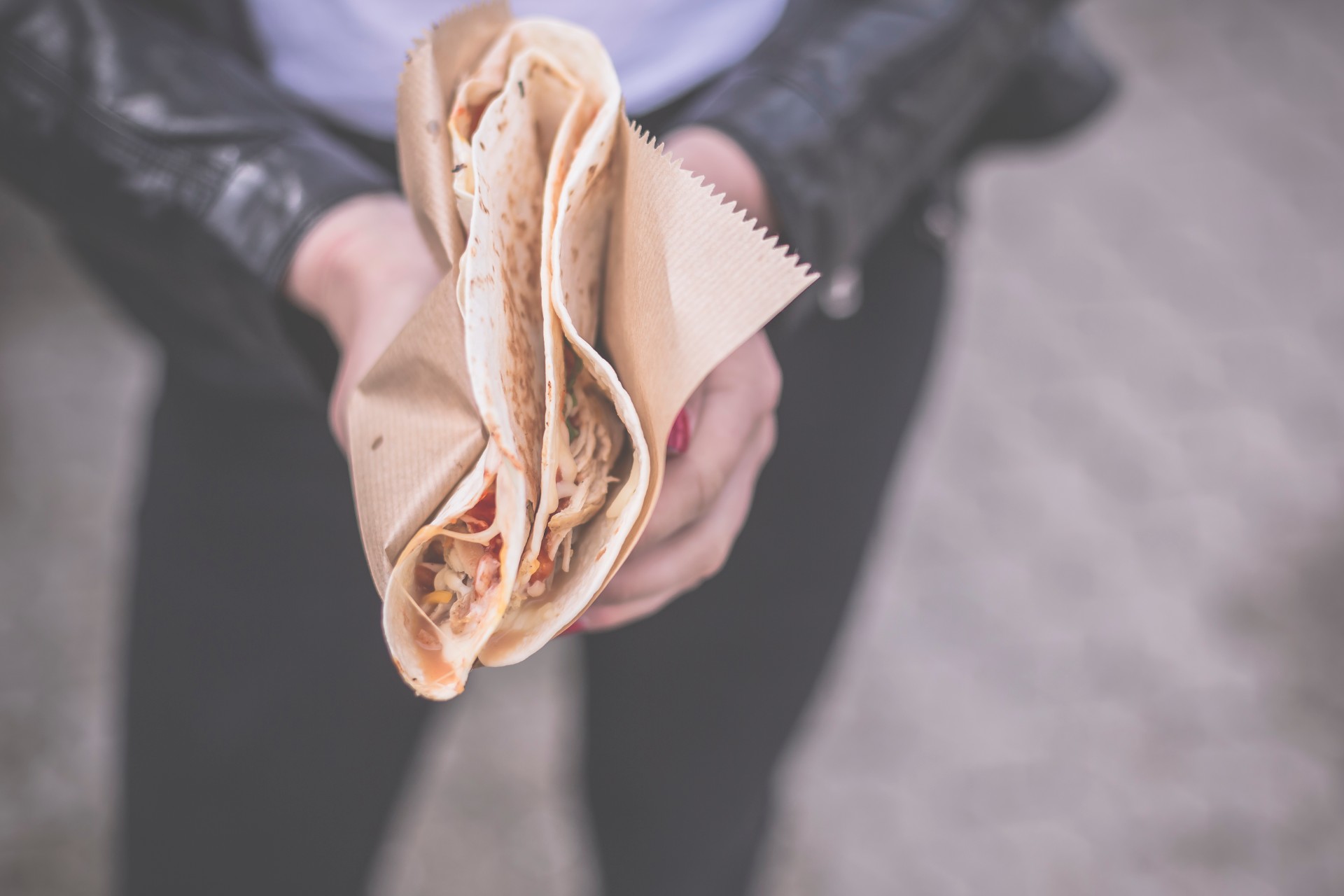 Person holding a quesadilla