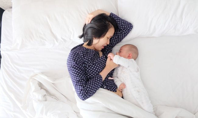 A mom and her baby in bed
