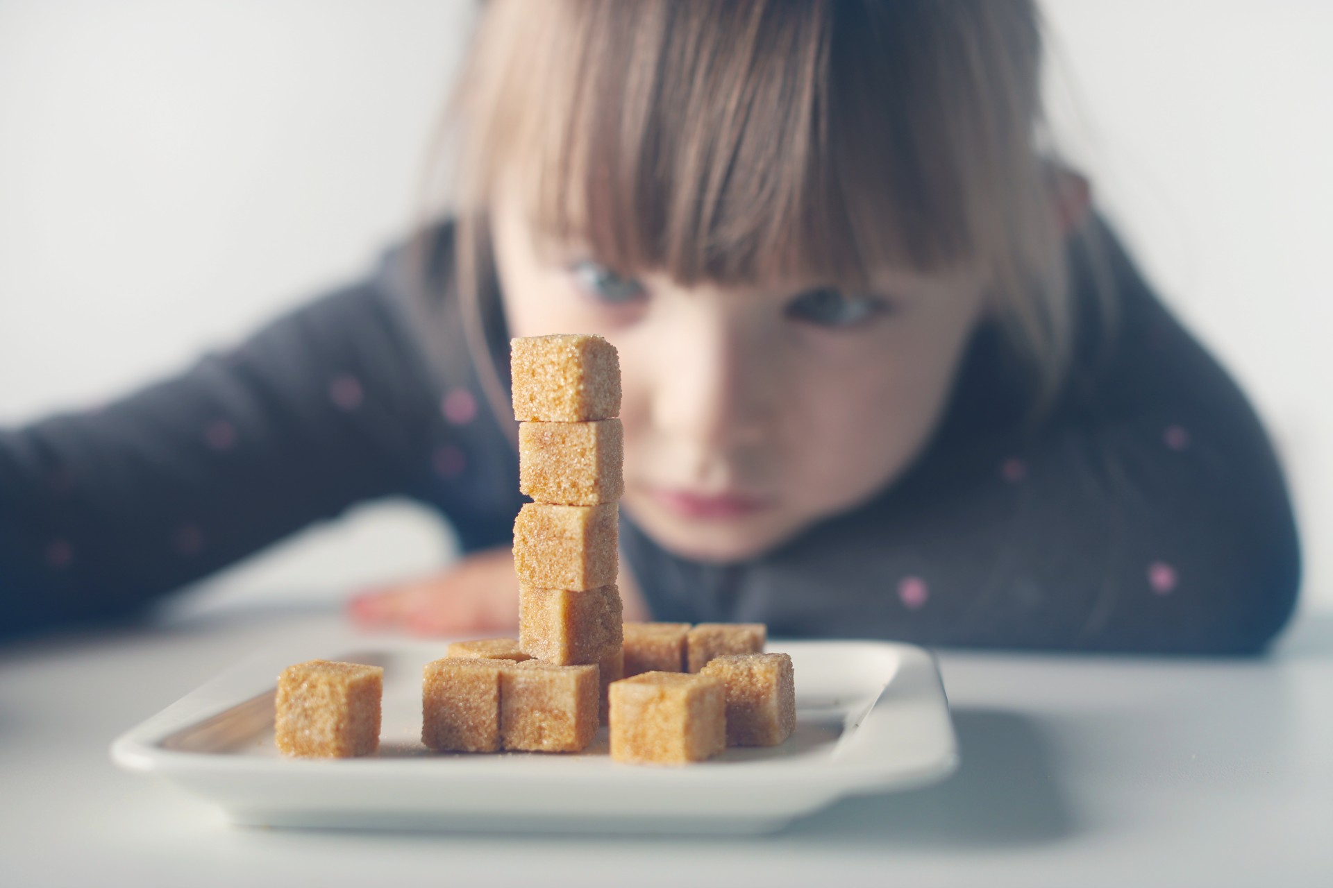 Child with plate of sugary treats