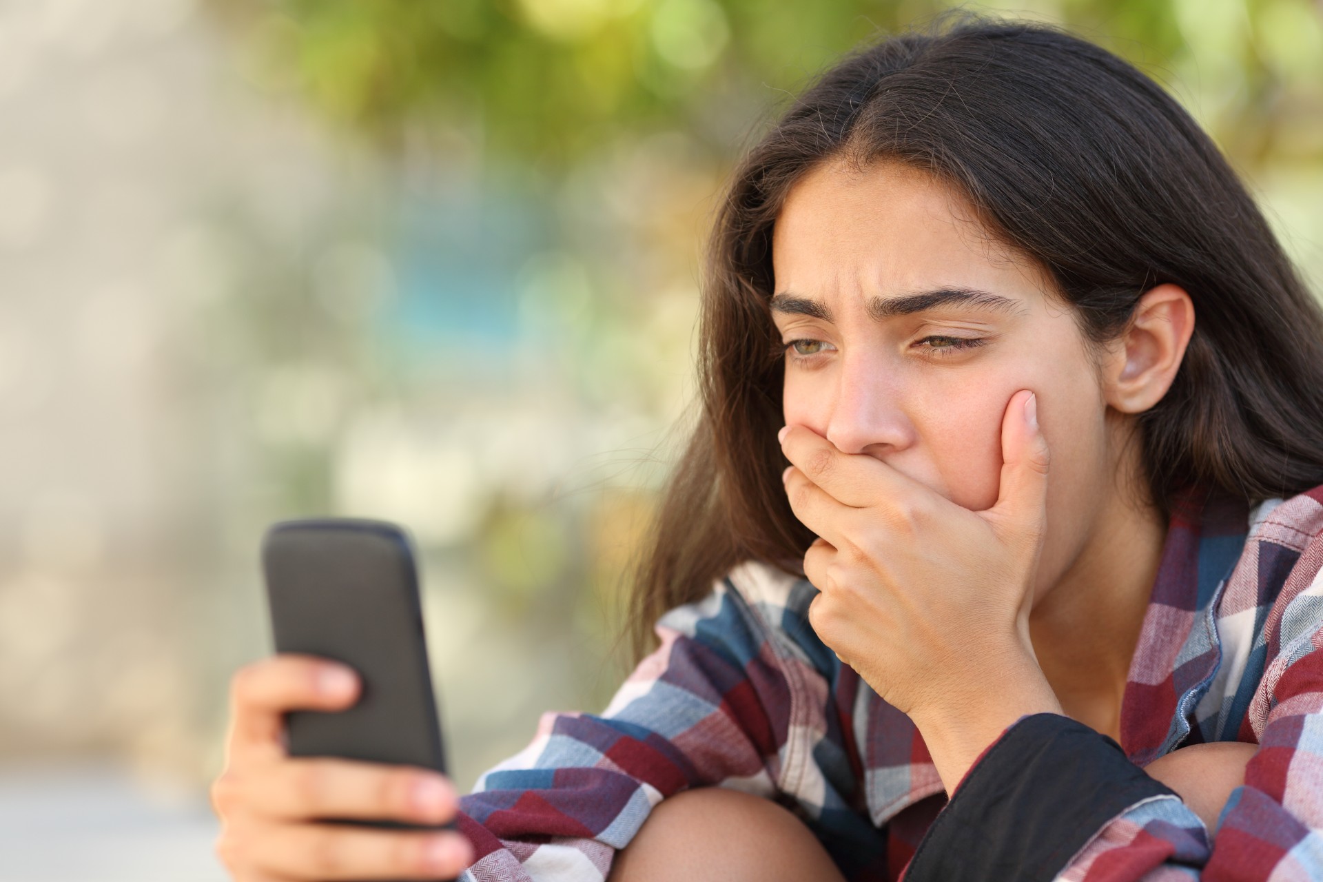 Teenage girl using smartphone outside