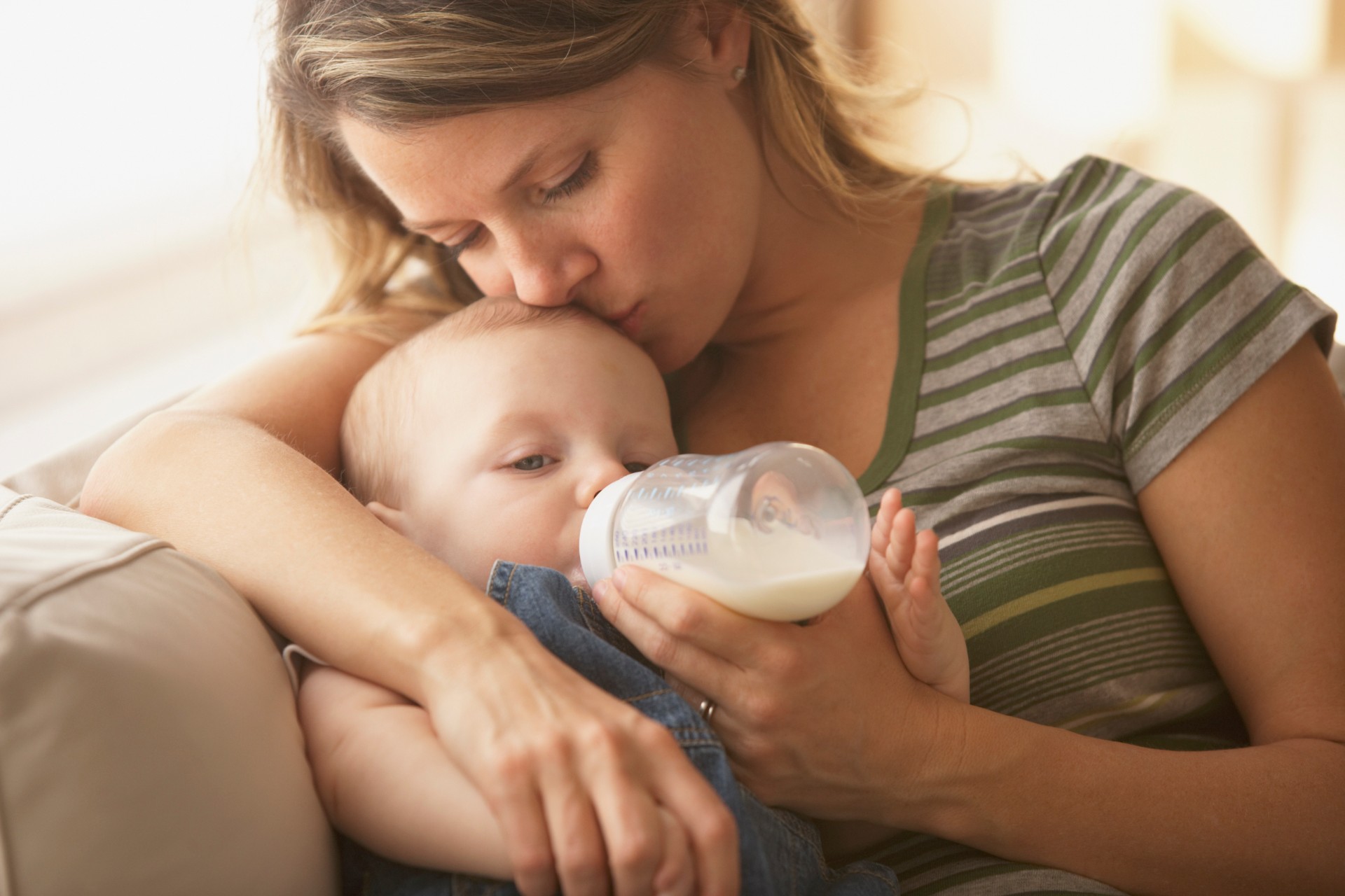 Mother feeding her baby a bottle.