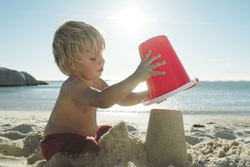 Boy making a sandcastle at the beach