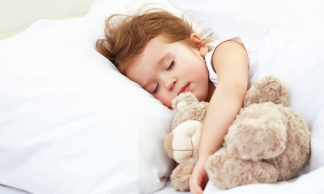 Toddler girl sleeping with plush bear